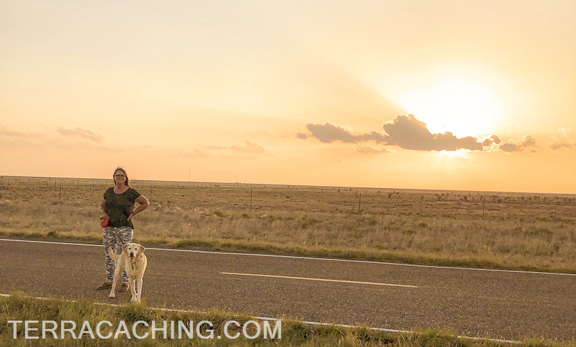 woman with dog at sunset